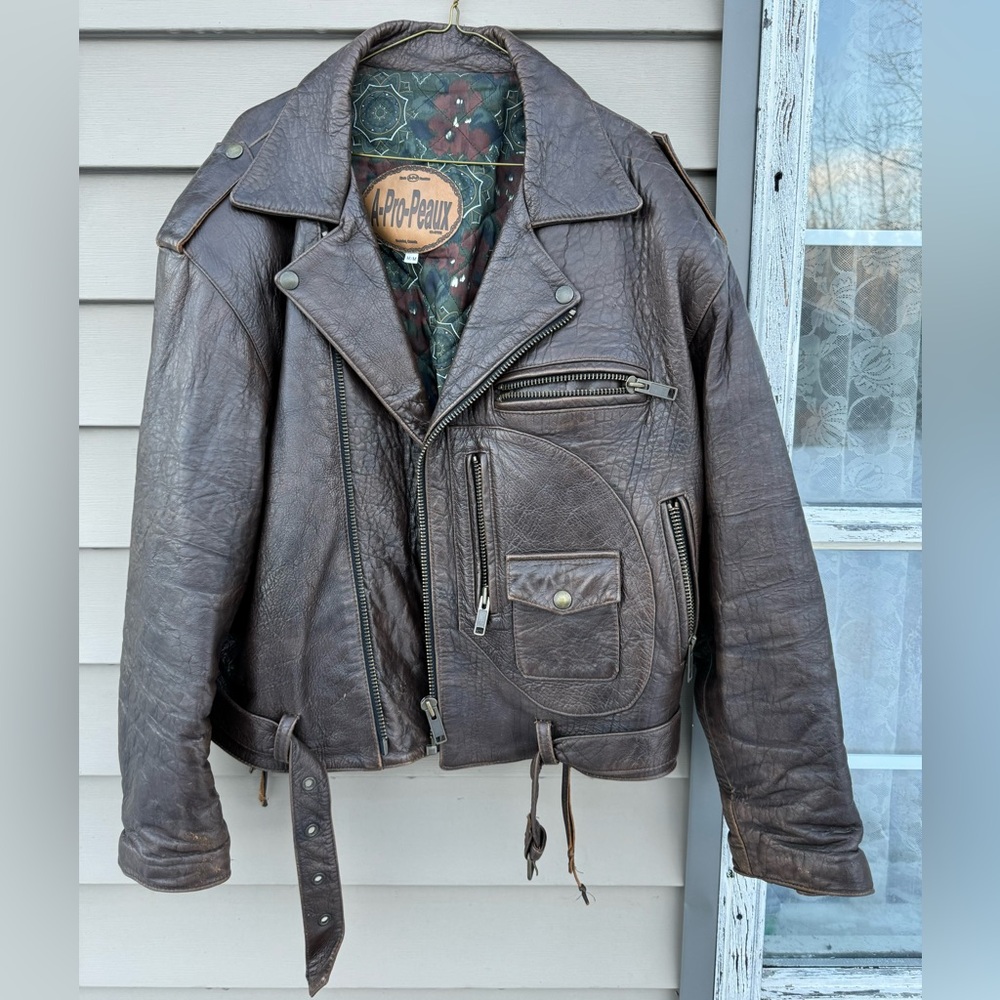 ‘90’s, but never worn, brown leather biker jacket.